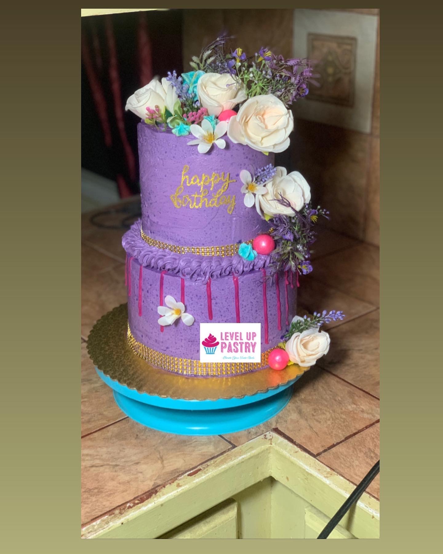 Purple two-tier floral celebration cake by Level Up Pastry