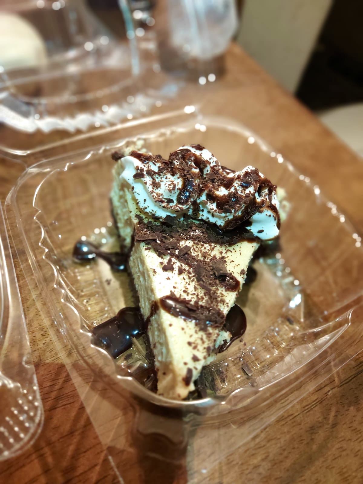 Chocolate-drizzled cheesecake slice